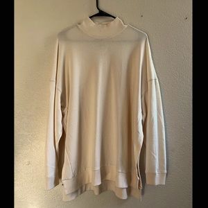 American eagle turtle neck cream sweater, with slits on the side.